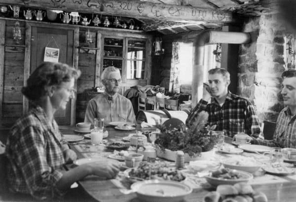 Black and white photo of family dining.