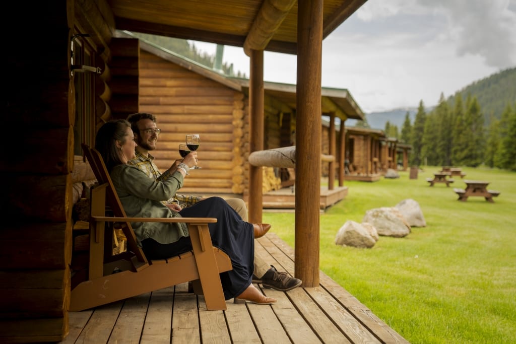 Couple on a ranch patio with wine glasses.