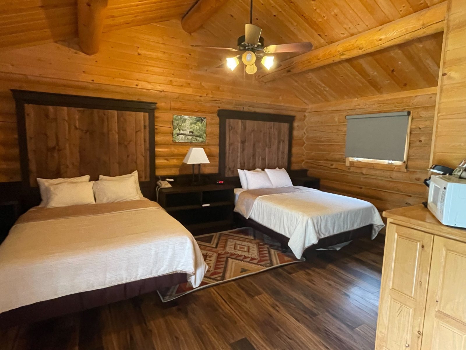 two queen beds of the deluxe log cabins
