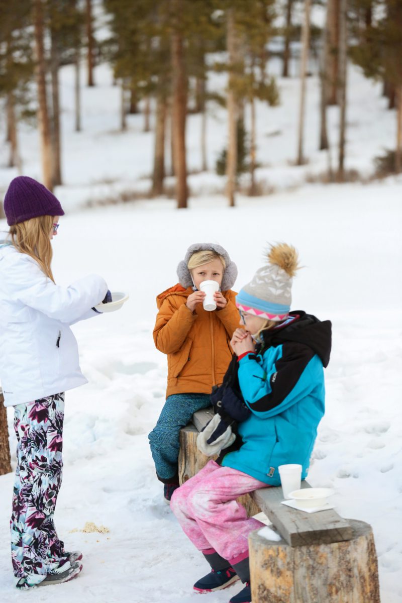 46 sligh ride fire pit drinks.Bree Hokana Photography Excited kids sipping hot drinks by a cozy fire during a memorable sleigh ride adventure