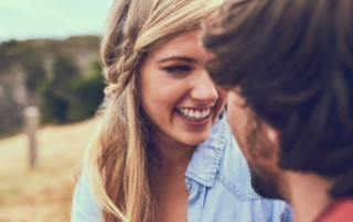 Romantic Getaways in Montana: A couple shares a smiling embrace during their Montana ranch vacation near Gallatin Gateway.